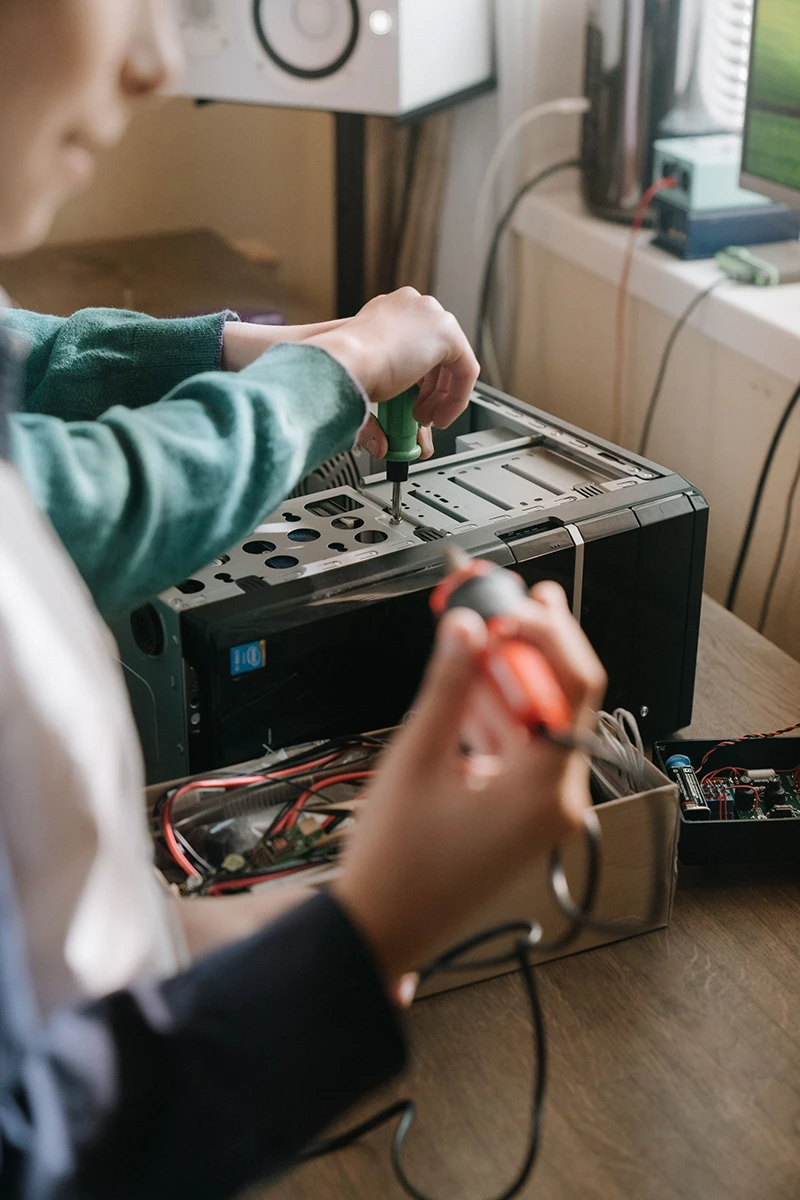 Computer technician working at a repair bench
