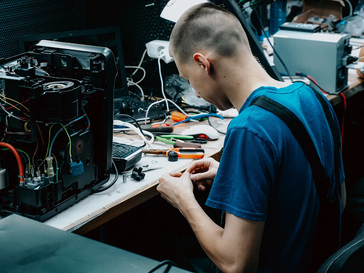 Technician diagnosing a computer at the workbench